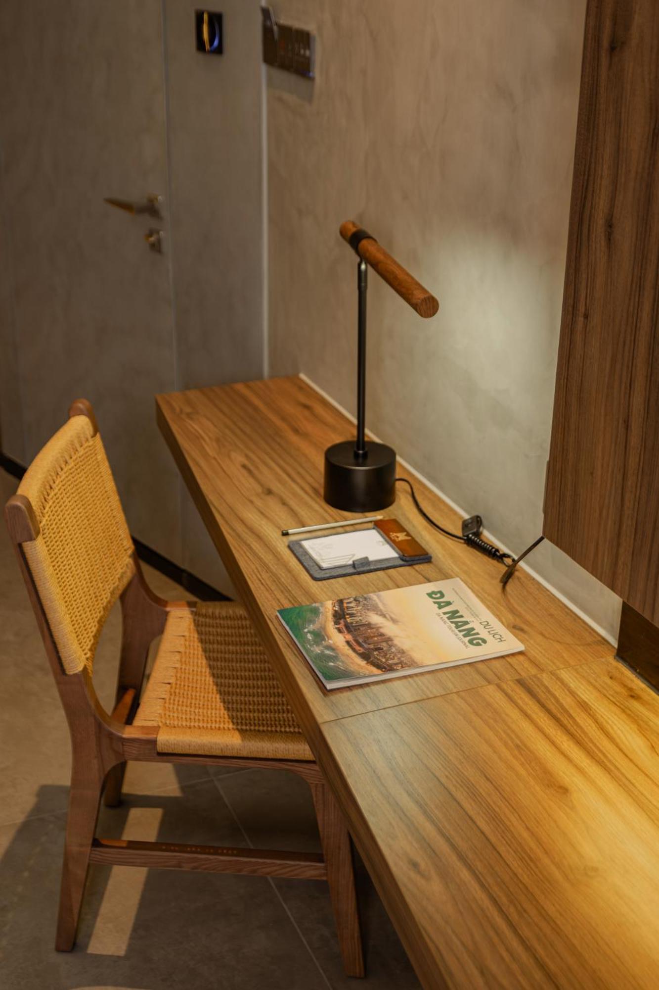 M Hotel Danang Екстериор снимка A desk with a magazine on it